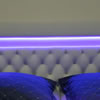 Podsvícení čalouněného čela postele LED páskem u kterého lze pomocí ovladače měnit barvy.